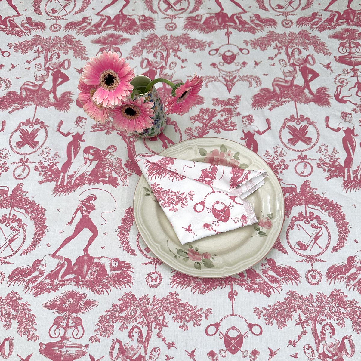 Pink toile table linens. Featuring a table cloth and dinner napkin. 