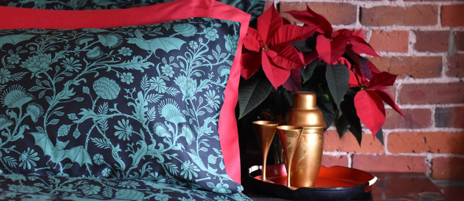 Gothic festive bedding by Sin in Linen. Green botanical patterns with bats. 