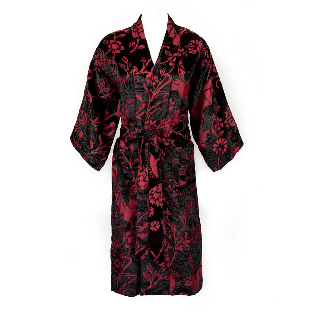 Burgundy red and black velvet robe with a gothic botanical pattern featuring bats and venus fly traps. On a mannequin form on a white background. 