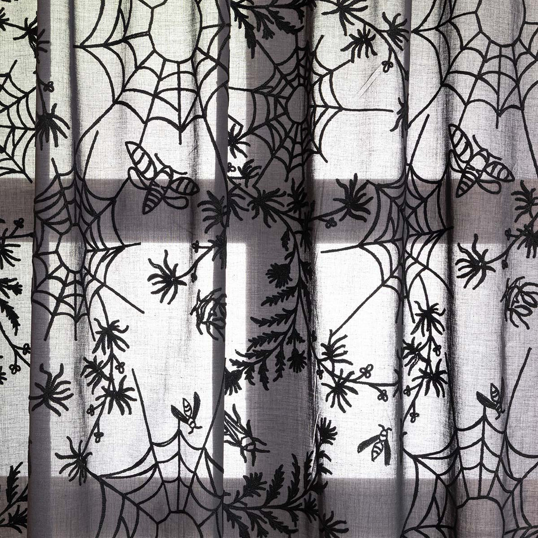 Close up of black cotton curtains with black spider web embroidery. Cottagecore and whimsigoth decor by Sin in Linen.