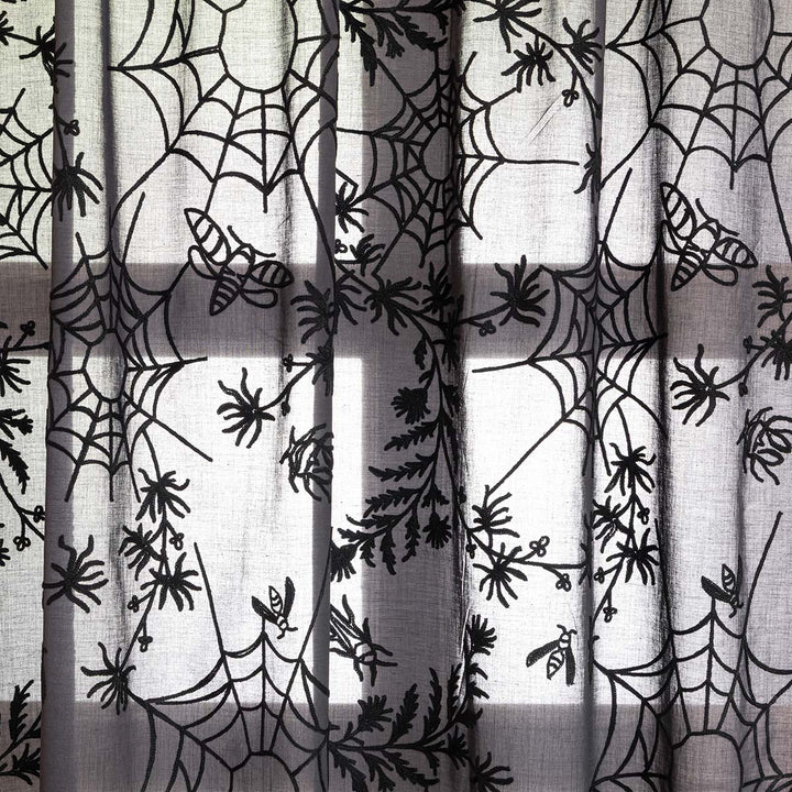 Close up of black cotton curtains with black spider web embroidery. Cottagecore and whimsigoth decor by Sin in Linen.