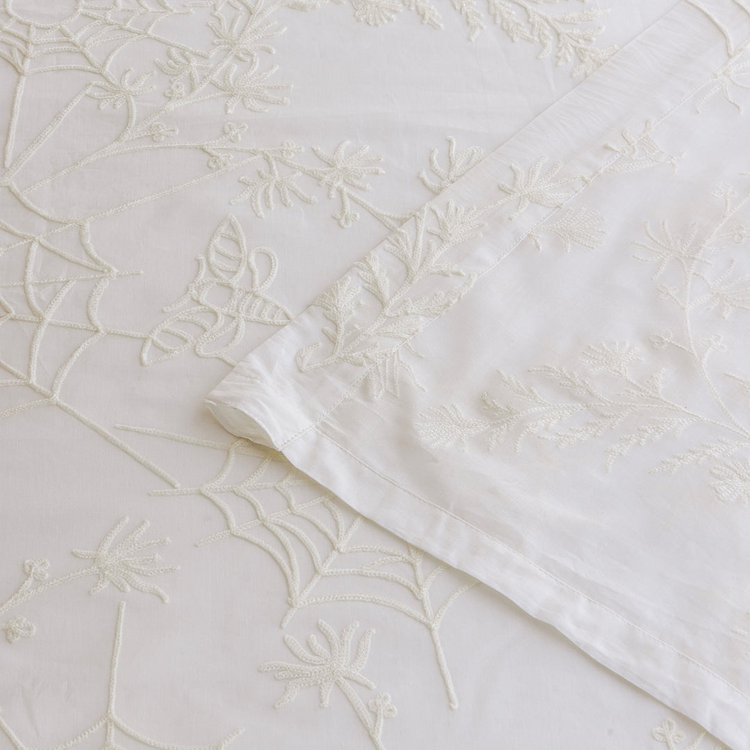 Corner of ivory cotton curtains with ivory spider web embroidery. Cottagecore and whimsigoth decor by Sin in Linen.