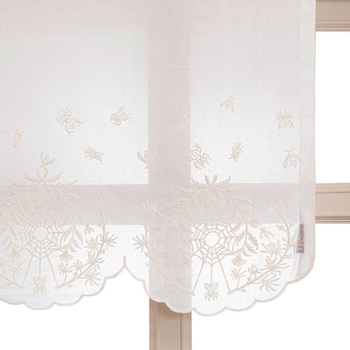 Ivory cotton window valance with ivory spider web cottagecore and whimsigoth embroidery in a window.