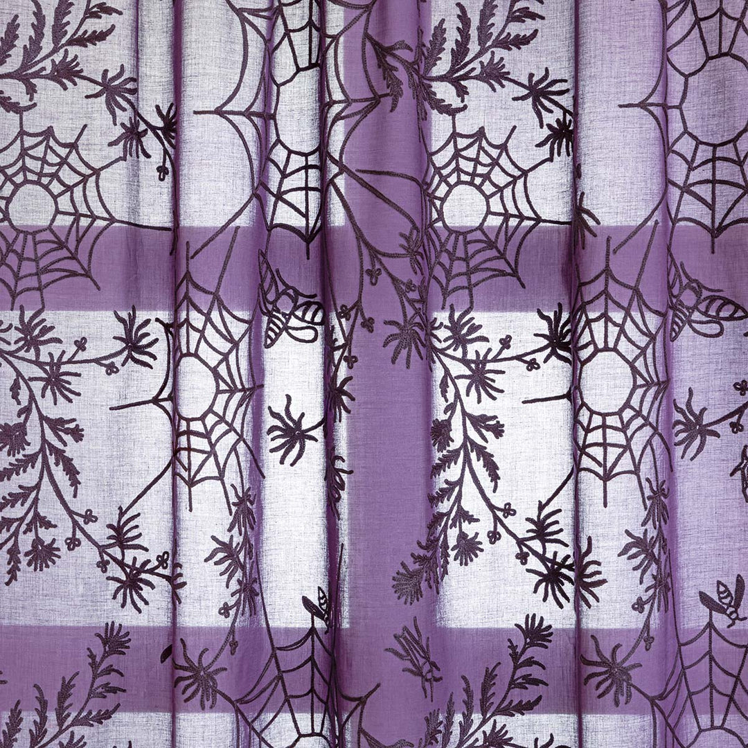 Close up of purple cotton curtains with purple spider web cottagecore and whimsigoth embroidery.