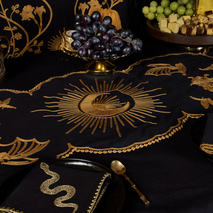 Bronze Embroidered Table Runner featuring motifs from Sin in Linen's Night Garden pattern. Make a dark, witchy table with this centerpiece. 