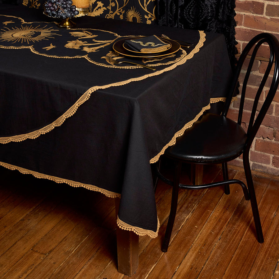 Black cotton tablecloths with bronze lace edges. A harvest toned witchy table starts with these tablecloths by Sin in Linen. Available in a rectangle and round. 