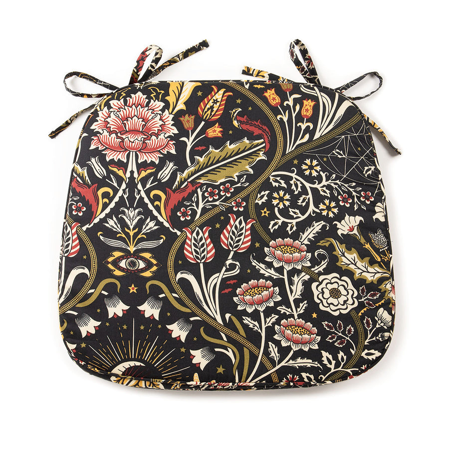 Gothic botanical chair pad with dark florals with moss and burgundy accents. On a white background.