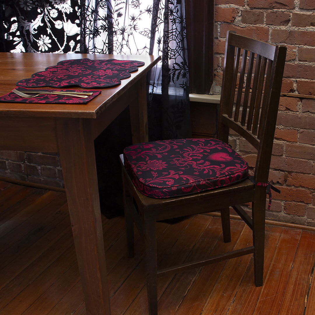A blush on placemat with a vintage inspired damask design with a matching napkin and chair pad.