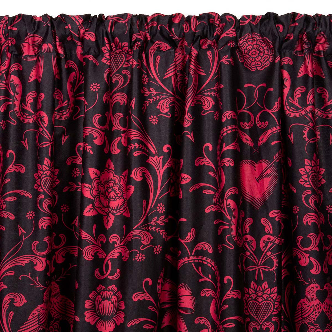 Love Bound curtain by Sin in Linen featuring a black background and a dark blush colored pattern with pierced hearts, serpents, and bows. Romantic rococo inspired design. 