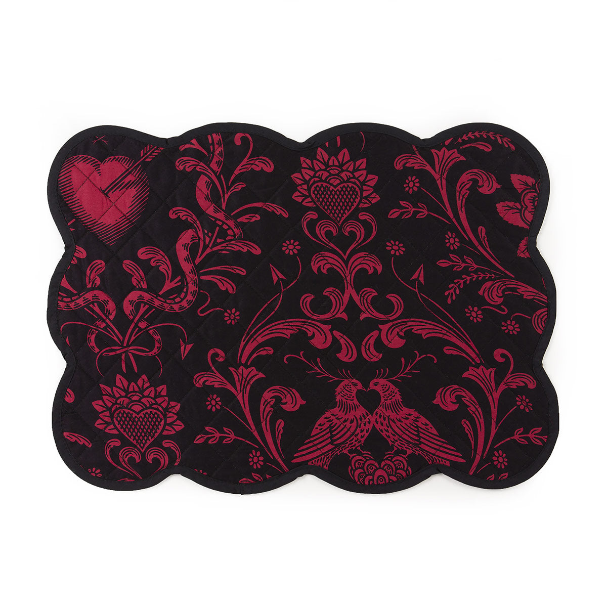 A deep blush on black quilted placemat with scalloped edges