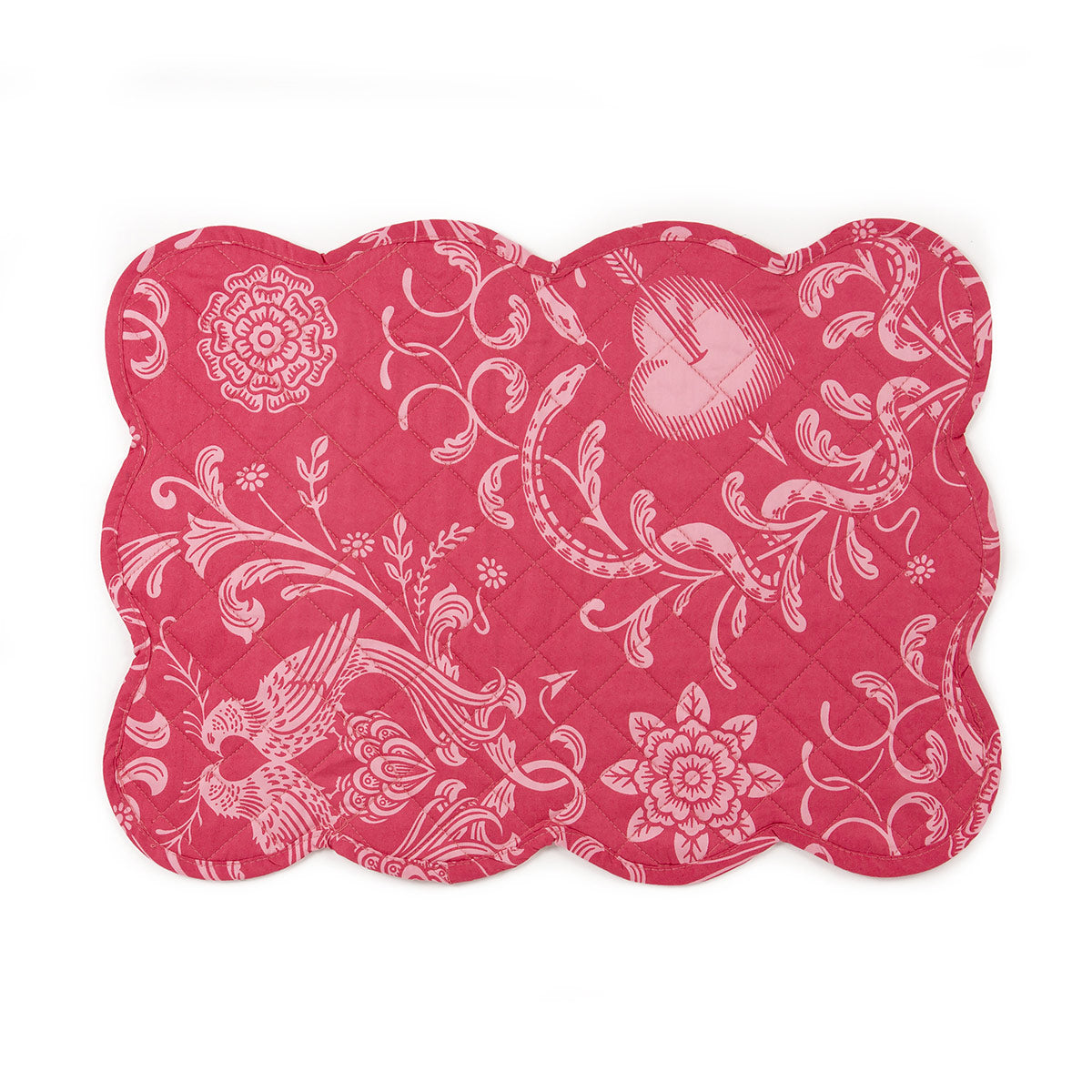A pink on pink quilted placemat with scalloped edges