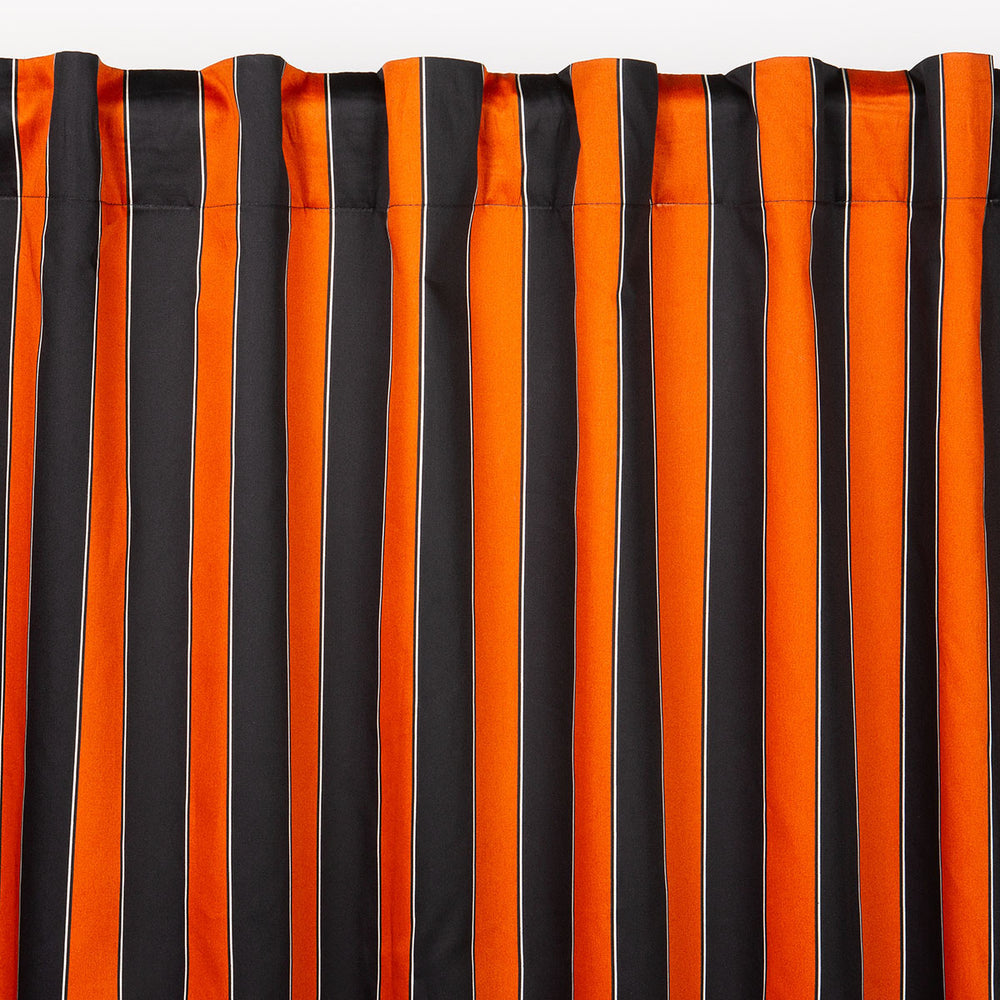 Striped curtain with orange and black vertical stripes. Vintage Halloween inspired decor by Sin in Linen. 