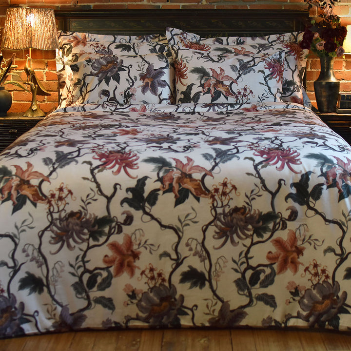 Romantic floral bedding by Sin in Linen. Nymphs bloom out of flowers on a light background in this fairy inspired bedding collection. Hues of lilac and rose abound. 
