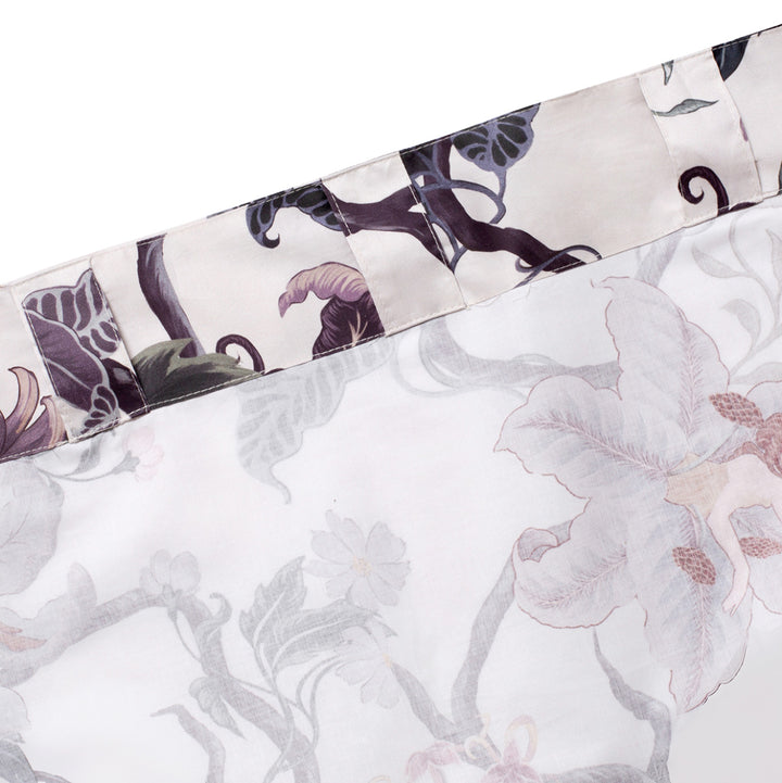 Romantic floral decor by Sin in Linen. Nymphs bloom out of flowers on a light background on these fairy inspired curtains. Showcases the curtain tab and rod pocket design. 