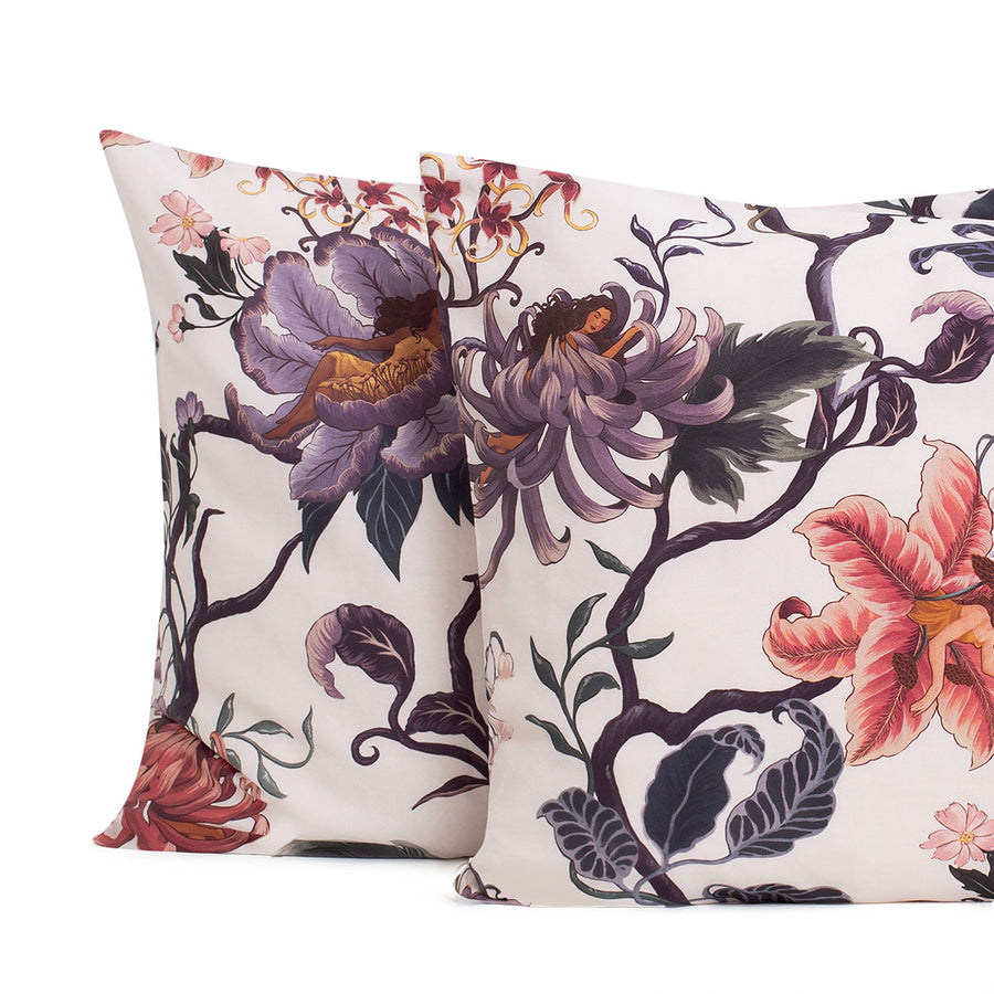 Romantic floral bedding by Sin in Linen. Nymphs bloom out of flowers on a light background on these fairy inspired pillowcases & shams. Hues of lilac and rose abound. 