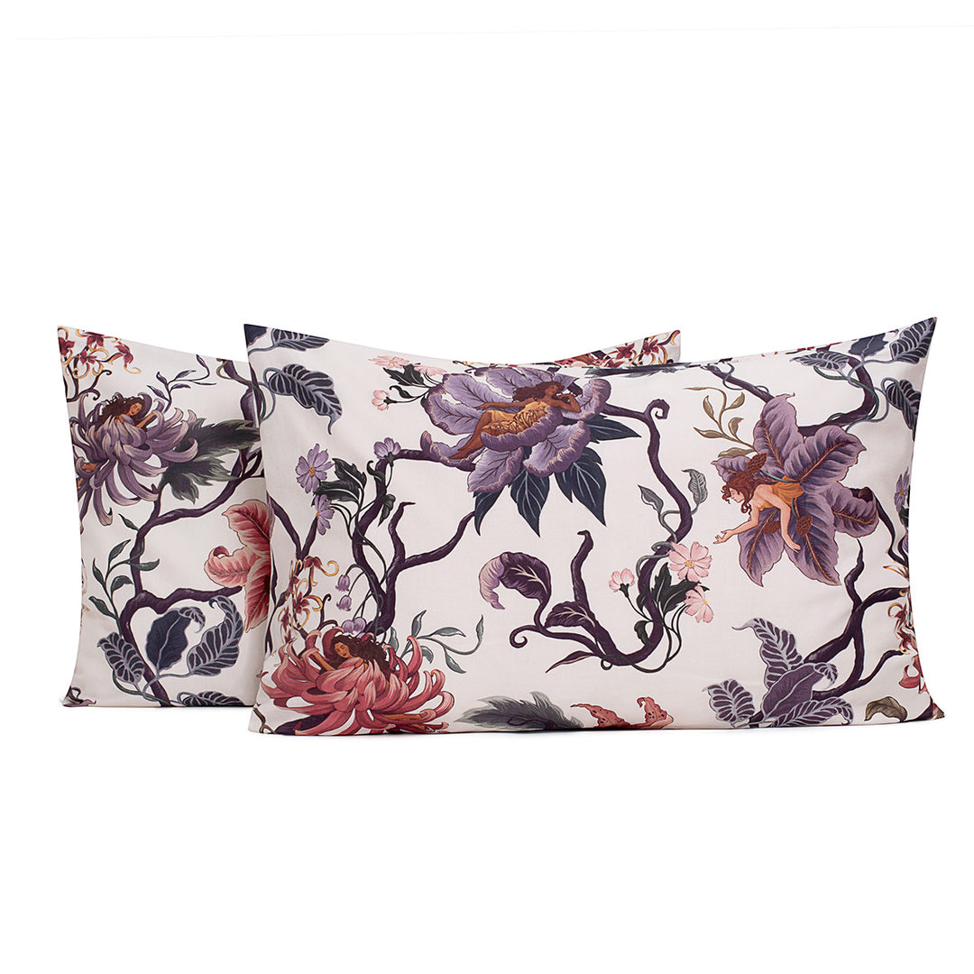 Romantic floral bedding by Sin in Linen. Nymphs bloom out of flowers on a light background on these fairy inspired pillowcases & shams. Hues of lilac and rose abound. 