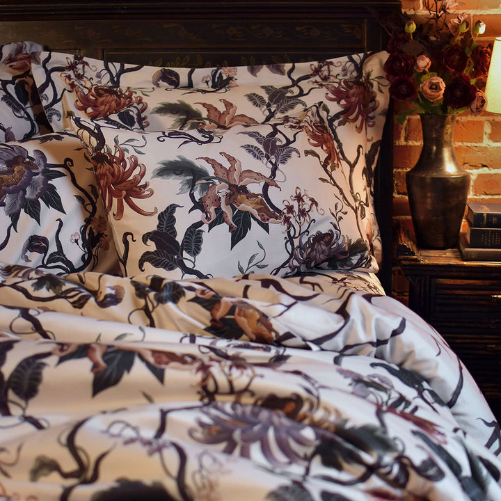Romantic floral bedding by Sin in Linen. Nymphs bloom out of flowers on a light background in this fairy inspired bedding collection. Hues of lilac and rose abound. 