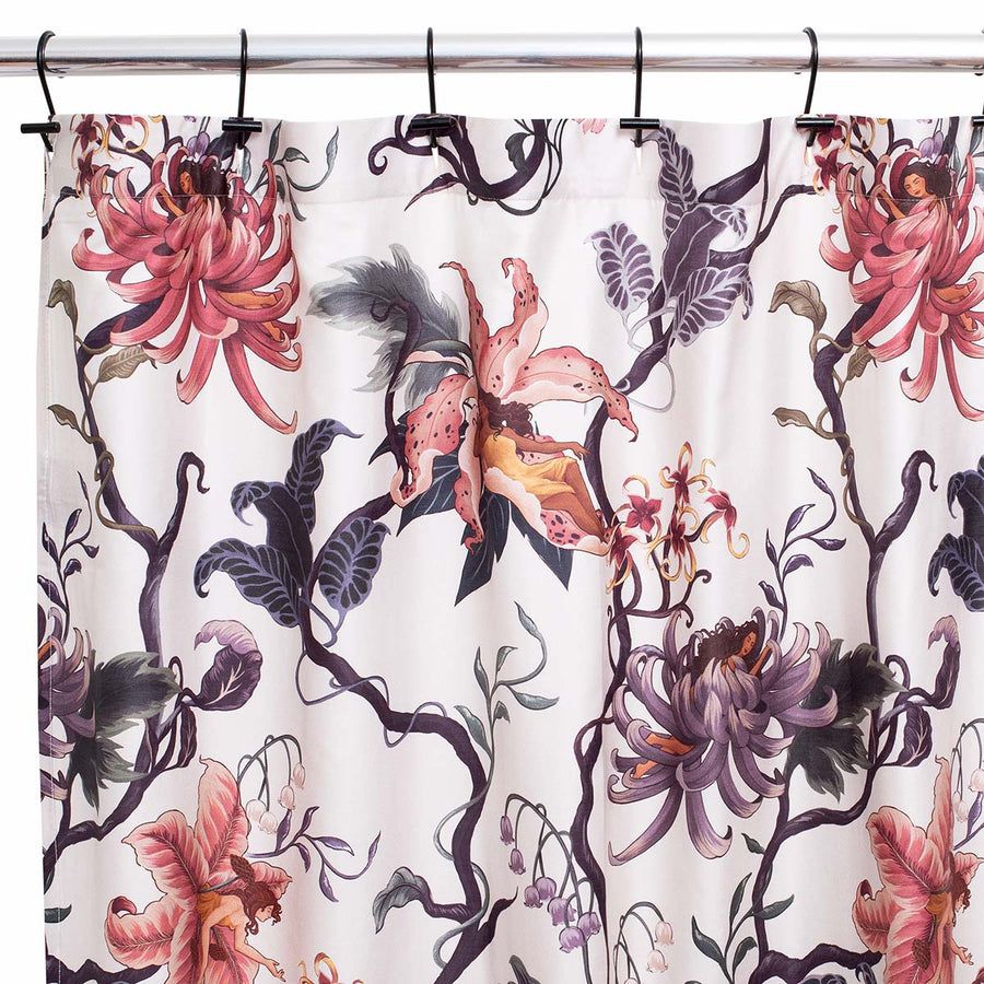 Romantic floral decor by Sin in Linen. Nymphs bloom out of flowers on a light background on this fairy inspired shower curtain. Hues of lilac and rose abound. 