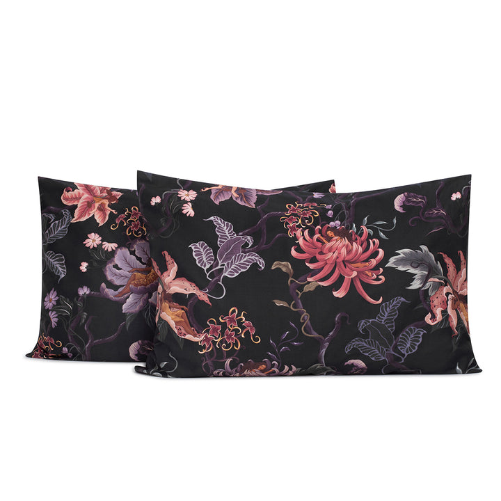 Romantic floral bedding by Sin in Linen. Nymphs bloom out of flowers on a dark background on these fairy inspired pillowcases & shams. Hues of lilac and rose abound. 