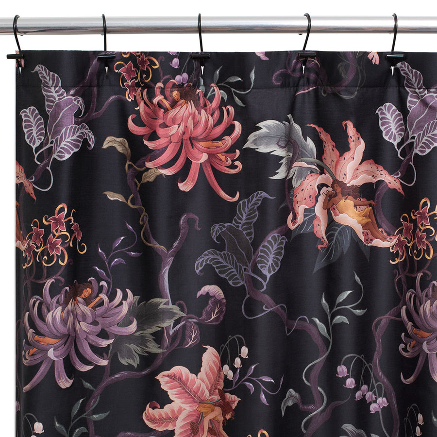 Romantic floral decor by Sin in Linen. Nymphs bloom out of flowers on a dark background on this fairy inspired shower curtain. Hues of lilac and rose abound. 