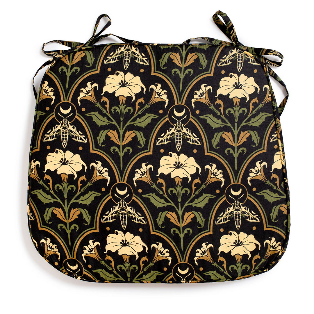 Datura Deco chair pads by Sin in Linen on a white background. Gothic Botanical, witchy table decor featuring datura blooms, moths, and moons. 