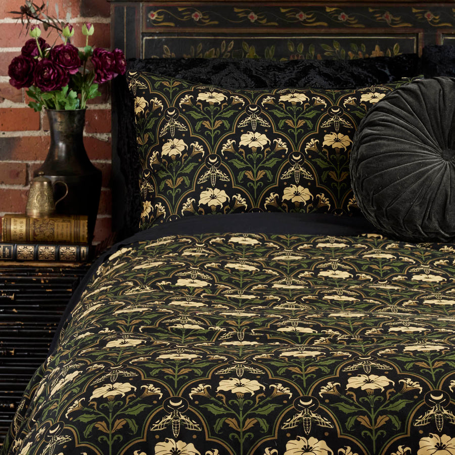 Gothic Botanical Art Deco Duvet Cover with the Datura Deco print featuring moths, gilded accents, and blooming florals. 