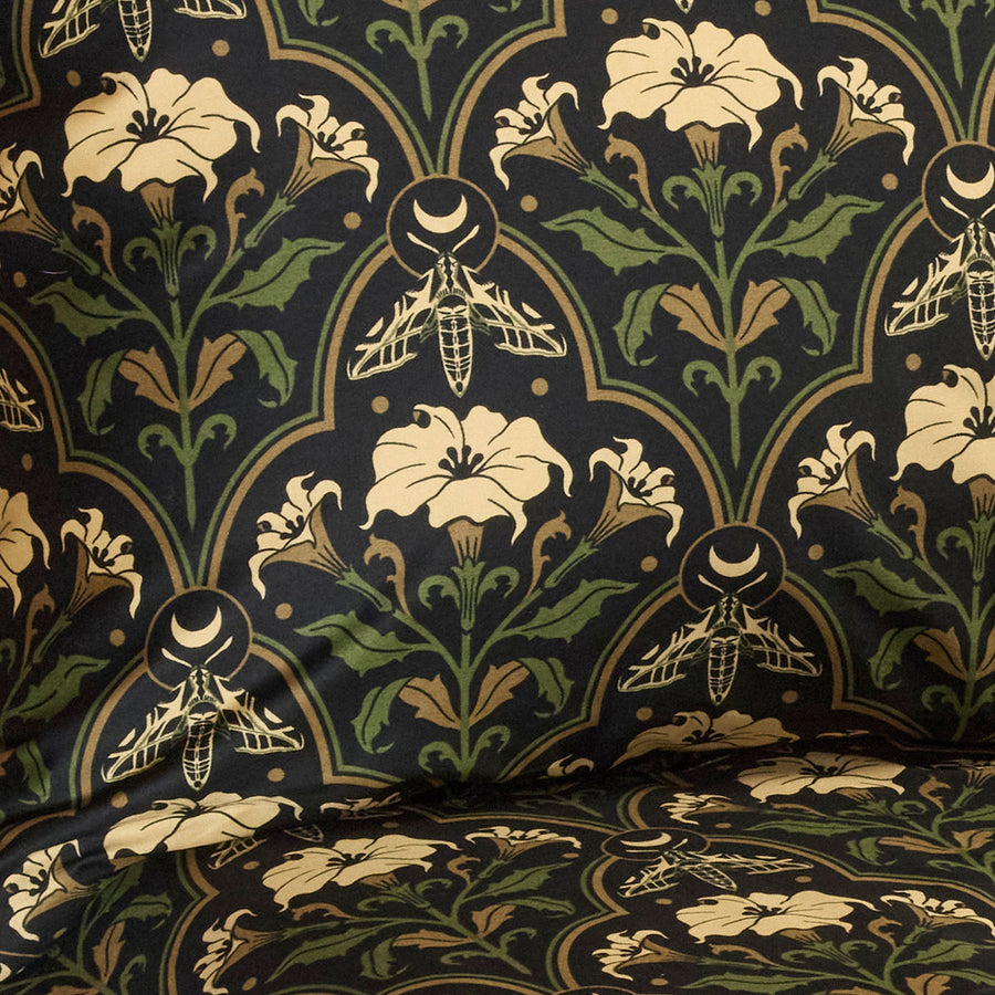 Datura Deco pattern swatch for Sin in Linen. Features moths, art deco accents, and crescent moons. 