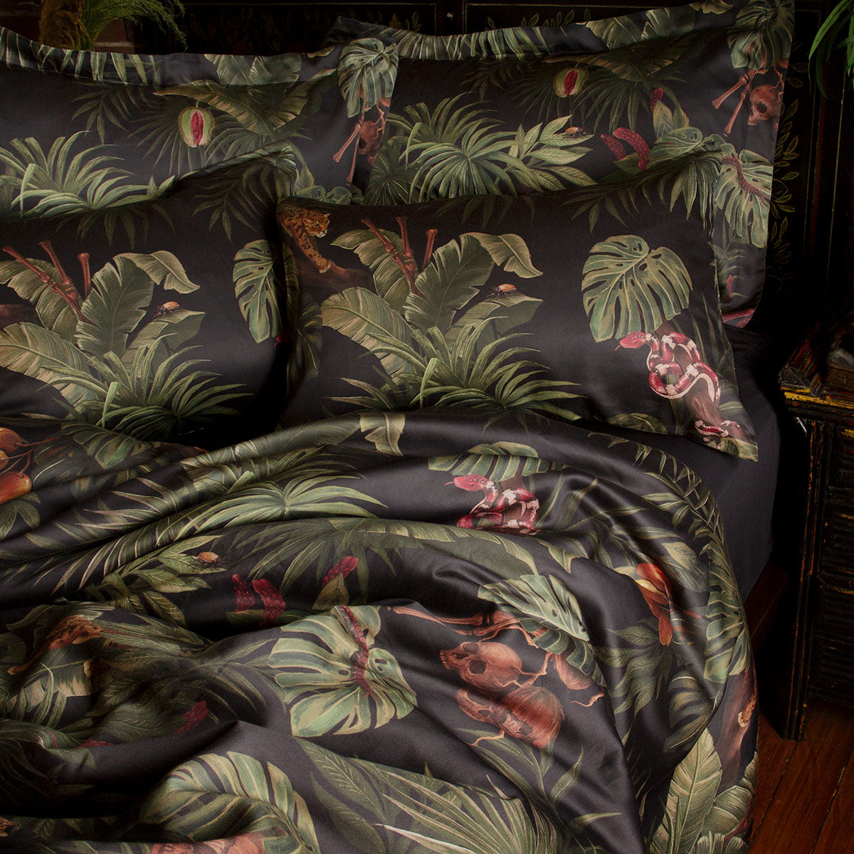 Sin in Linen's Tropical Gothic bedding and decor collection, Jungle Noir. Featuring lush botanicals, leopards, snakes, and vintage inspired elements, this 100% cotton collection includes duvet covers, pillowcases, curtains, and shower curtains. 