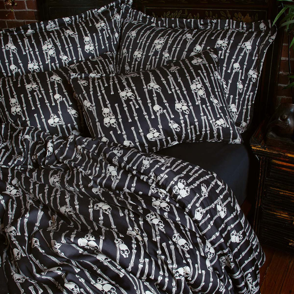Sin in Linen's Bone Grove Bedding Collection. A bamboo-inspired print featuring hidden skulls for a gothic, vintage inspired bedroom.