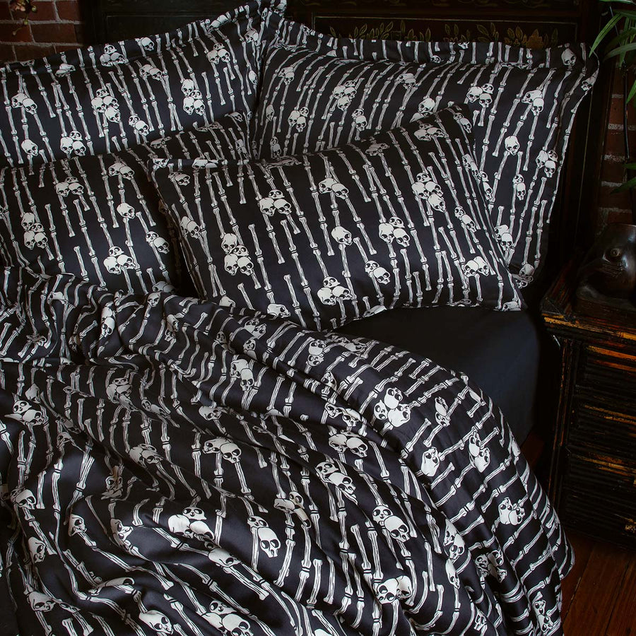 Sin in Linen's Bone Grove Bedding Collection. A bamboo-inspired print featuring hidden skulls for a gothic, vintage inspired bedroom.