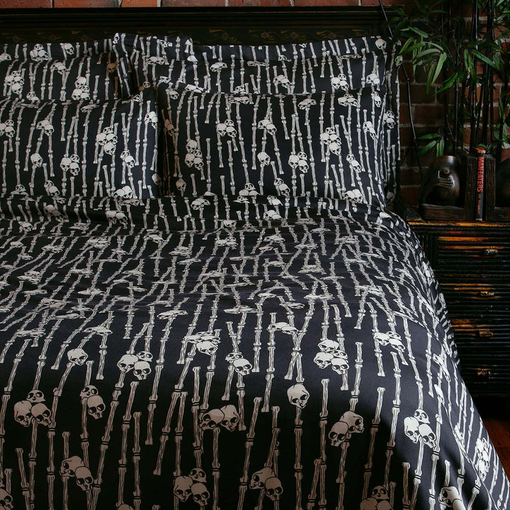 Sin in Linen's Bone Grove Bedding Collection. A bamboo-inspired print featuring hidden skulls for a gothic, vintage inspired bedroom.