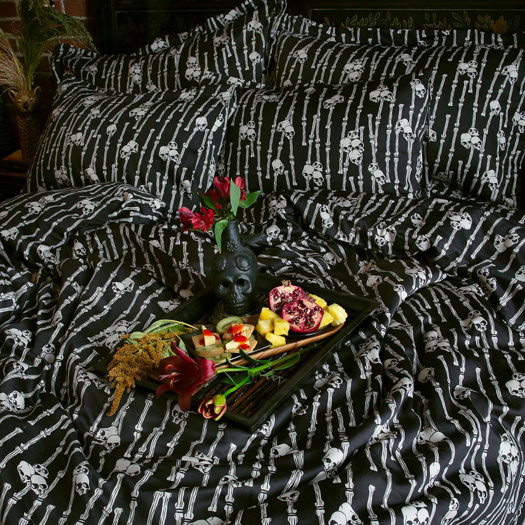 Sin in Linen's Bone Grove Bedding Collection. A bamboo-inspired print featuring hidden skulls for a gothic, vintage inspired bedroom.