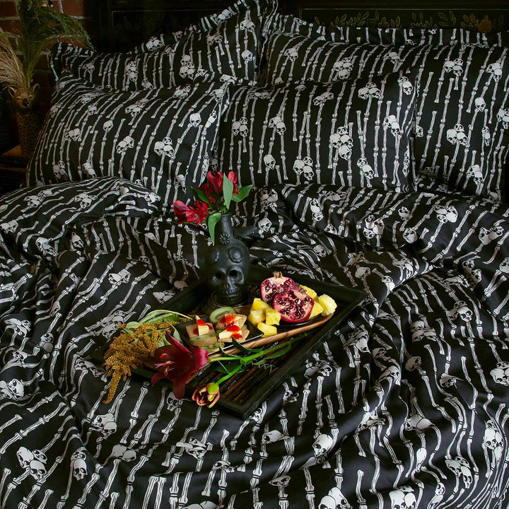 Sin in Linen's Bone Grove Bedding Collection. A bamboo-inspired print featuring hidden skulls for a gothic, vintage inspired bedroom.