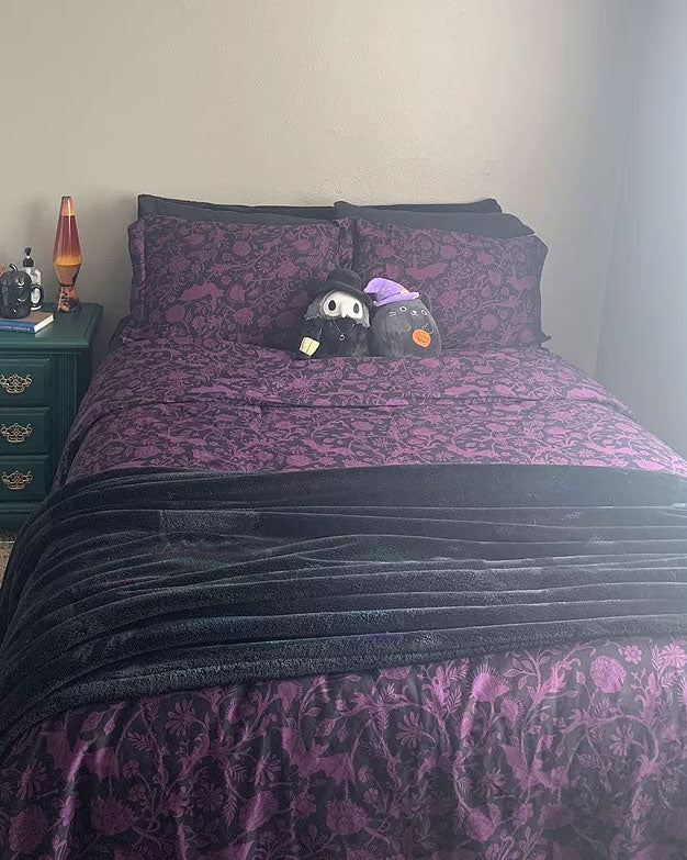 Purple Elysian Fields gothic Bat bedding on a bed. 