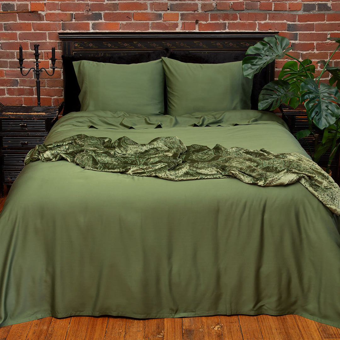 Moss green bamboo bedding that includes sheet sets and pillowcases. 
