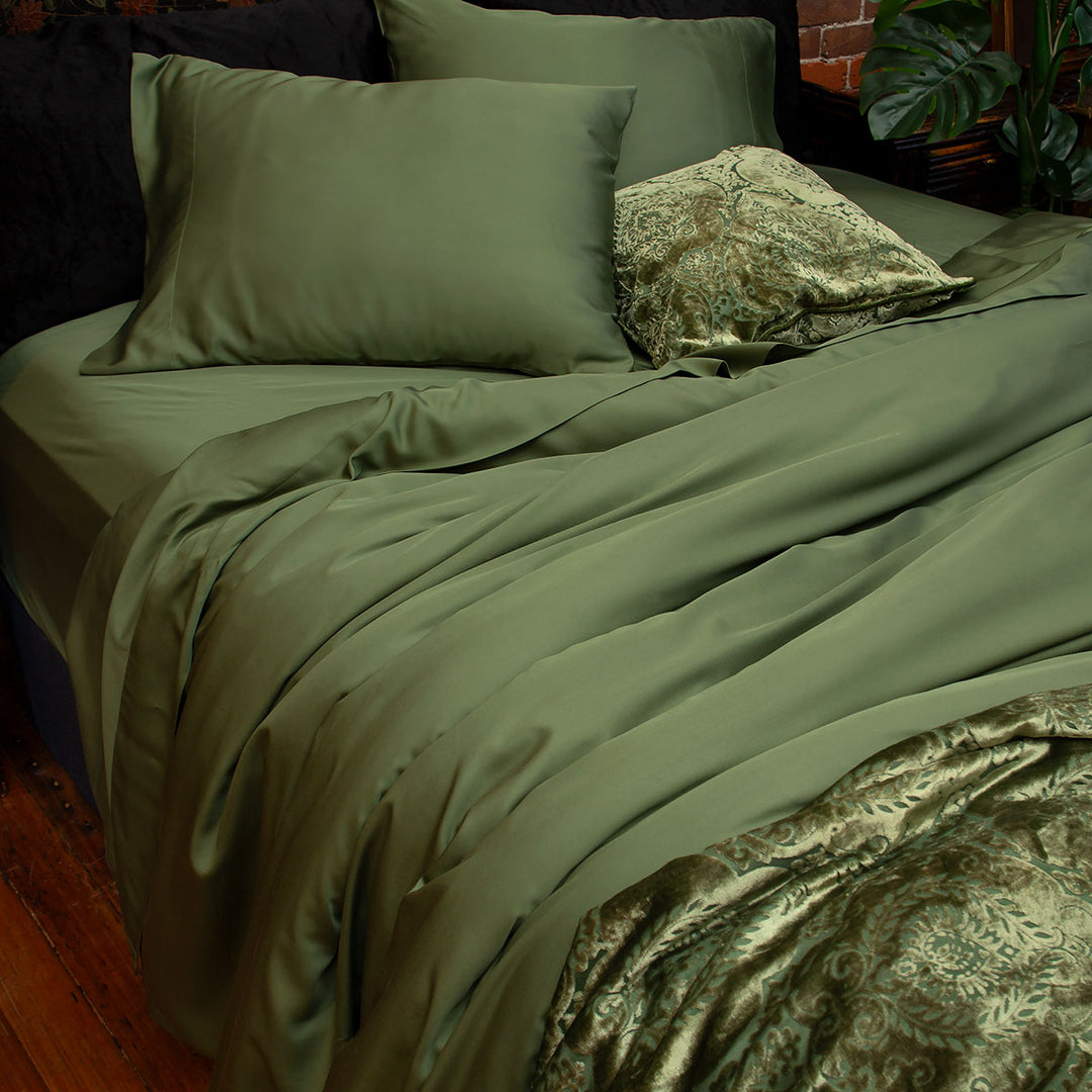 Moss green bamboo sheets with velvet accents. 