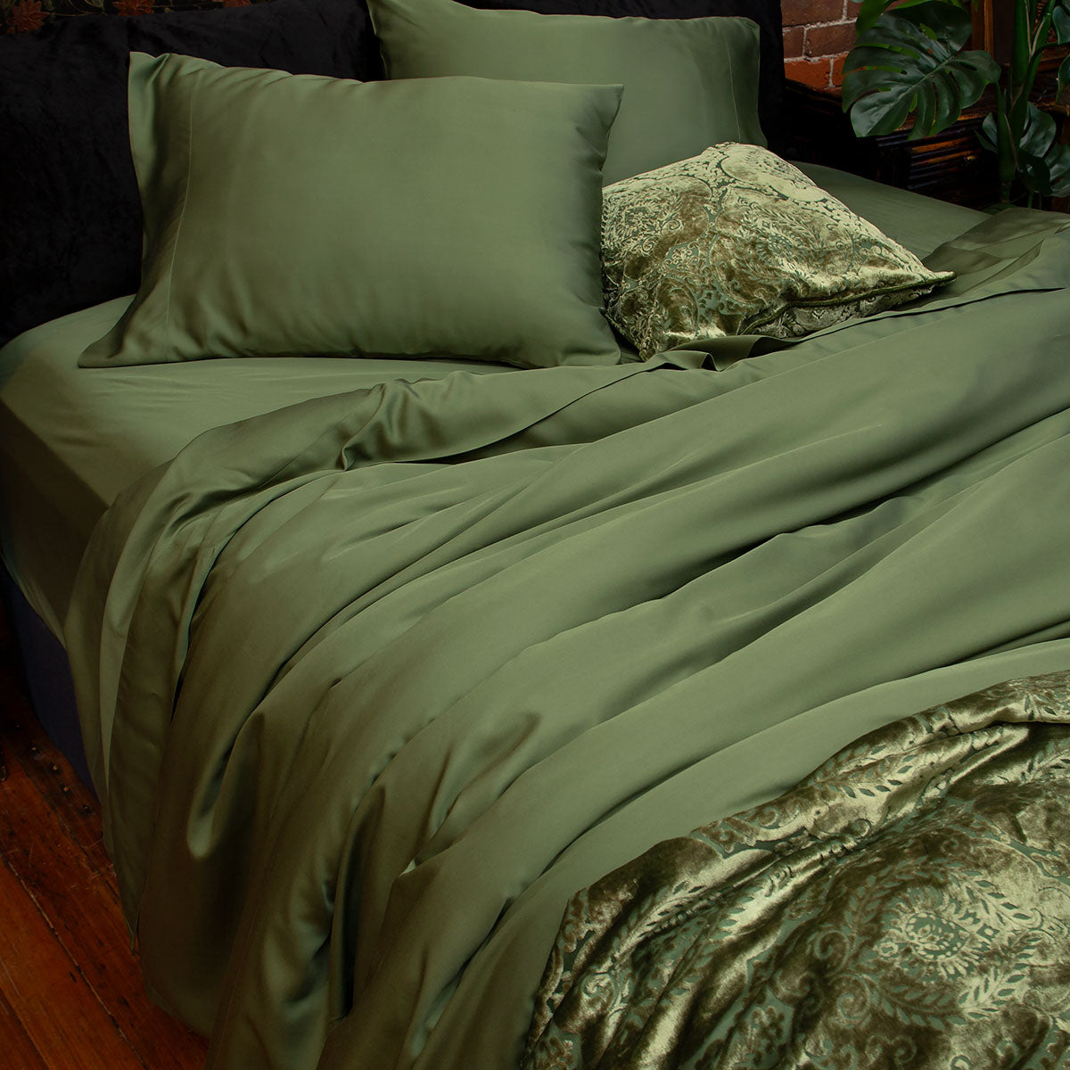 Moss green bamboo sheets with velvet accents. 