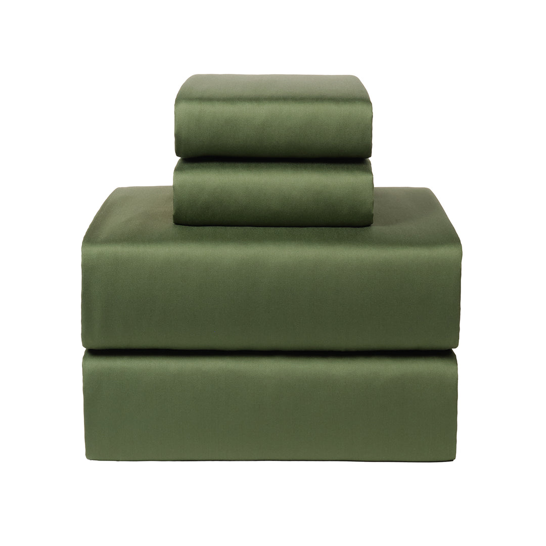 Green bamboo bed sheets on a white background. 