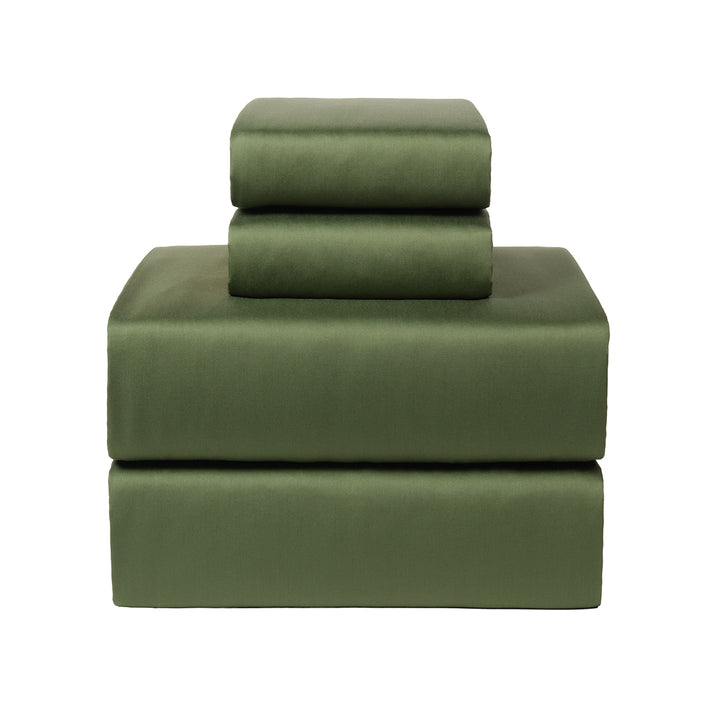 Green bamboo bed sheets on a white background. 