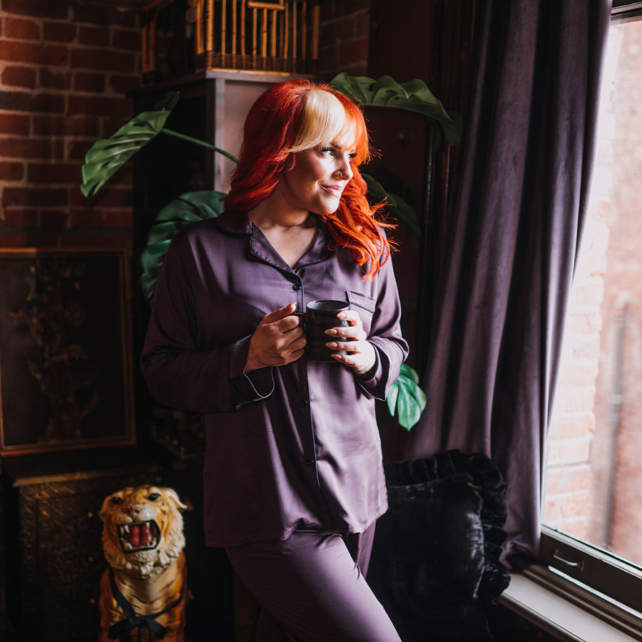 Purple bamboo pajamas with black buttons and black piping. 