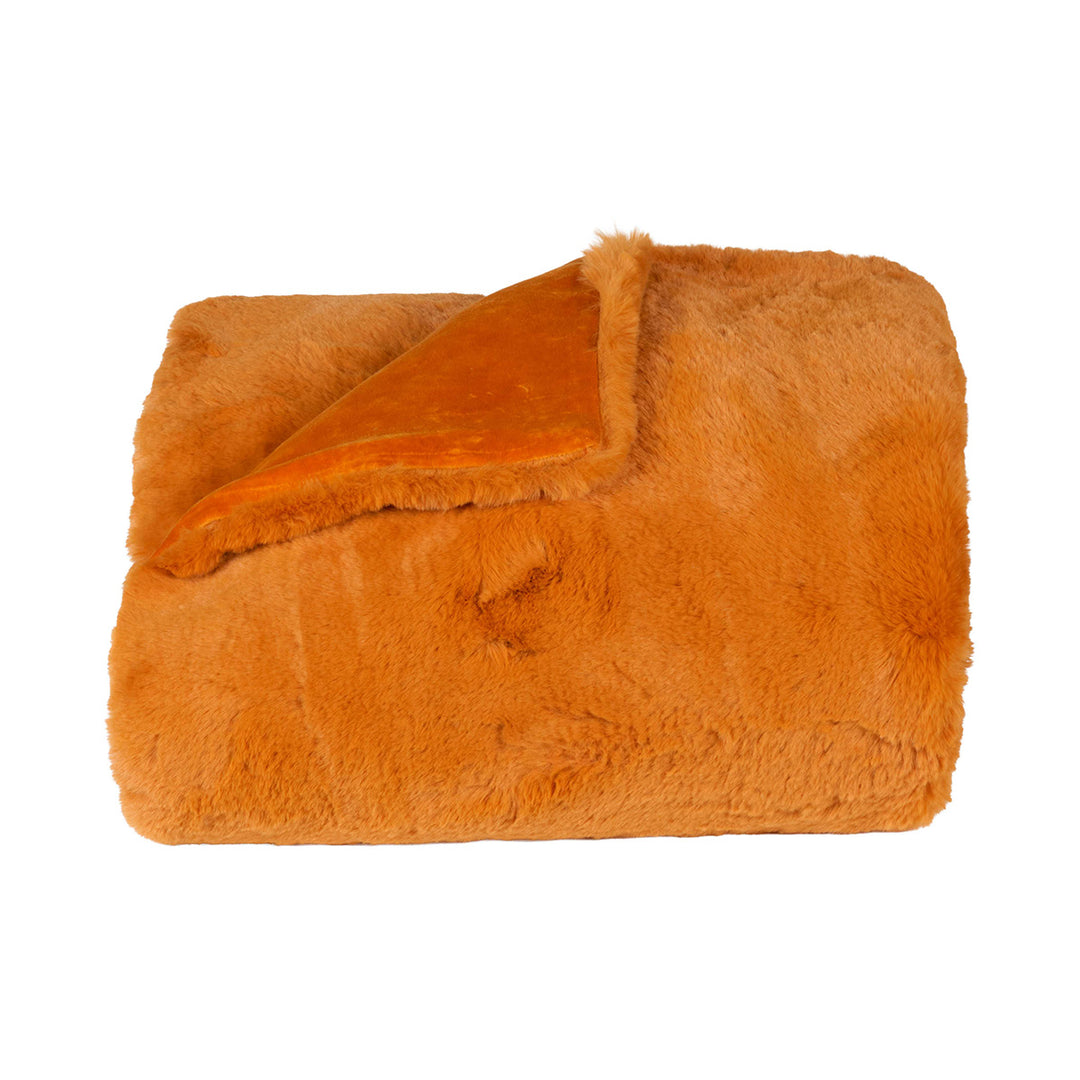 Pumpkin orange faux fur blanket on a white background.