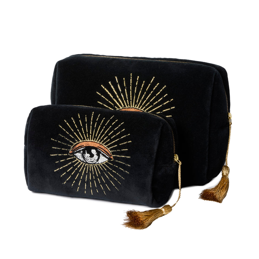 Black velvet pouches with gold eye design and tassels on a white background