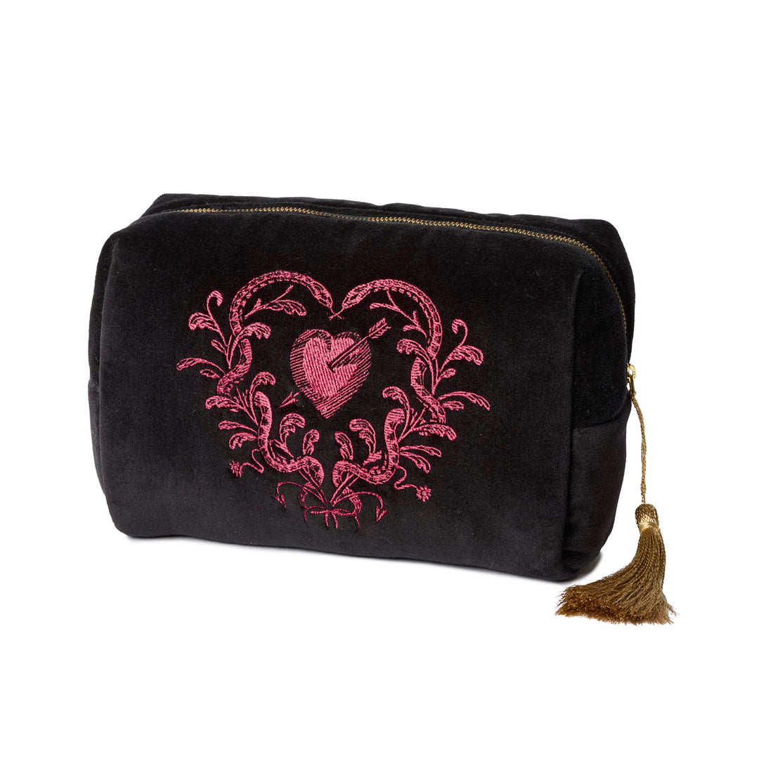 Black velvet toiletry bag with pink heart designs with snakes and gold tassels on a white background