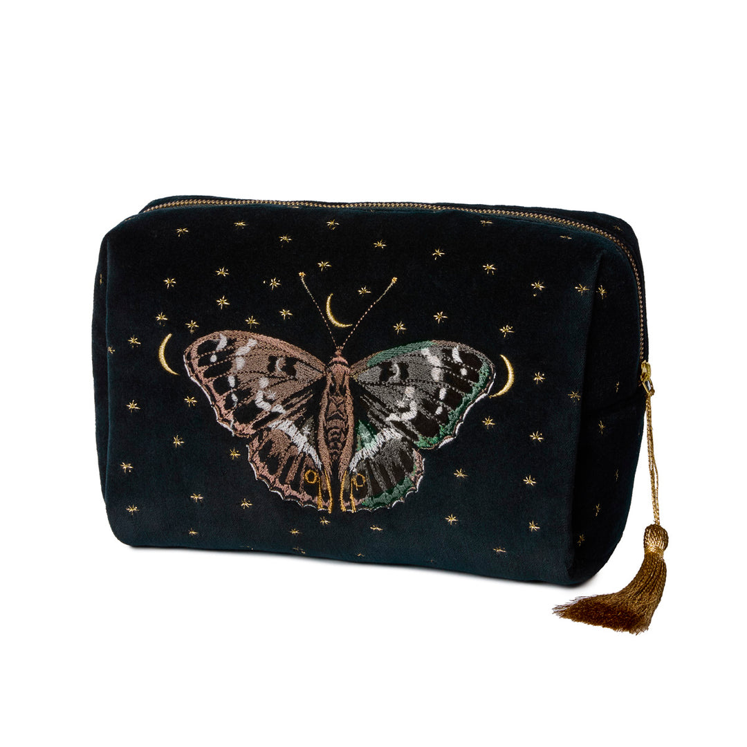 Black embroidered toiletry bag with moth design and golden tassel on a white background.