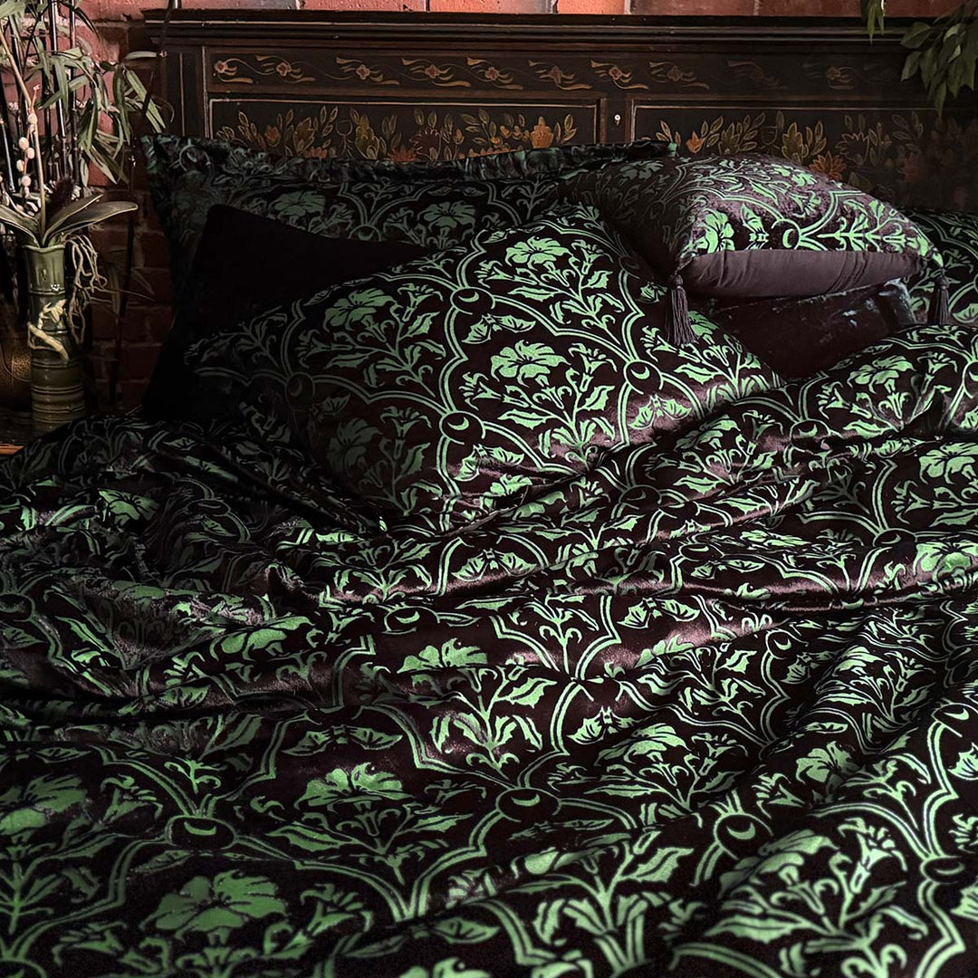 Sin in Linen's Velvet Datura bedding. Green gothic botanical pattern featuring datura blooms and bats in a flocked velvet design. Dark, witchy decor. 