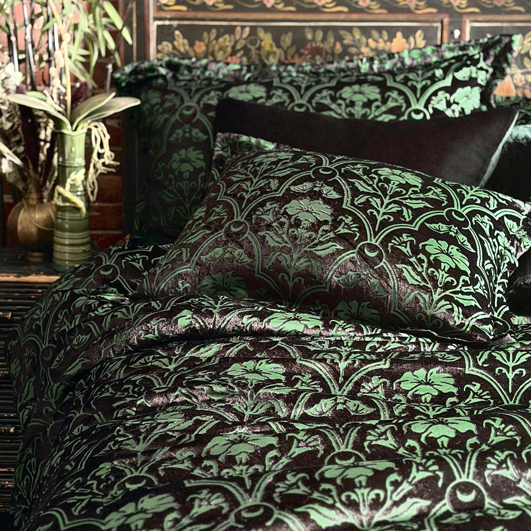 Sin in Linen's Velvet Datura bedding. Green gothic botanical pattern featuring datura blooms and bats in a flocked velvet design. Dark, witchy decor. 