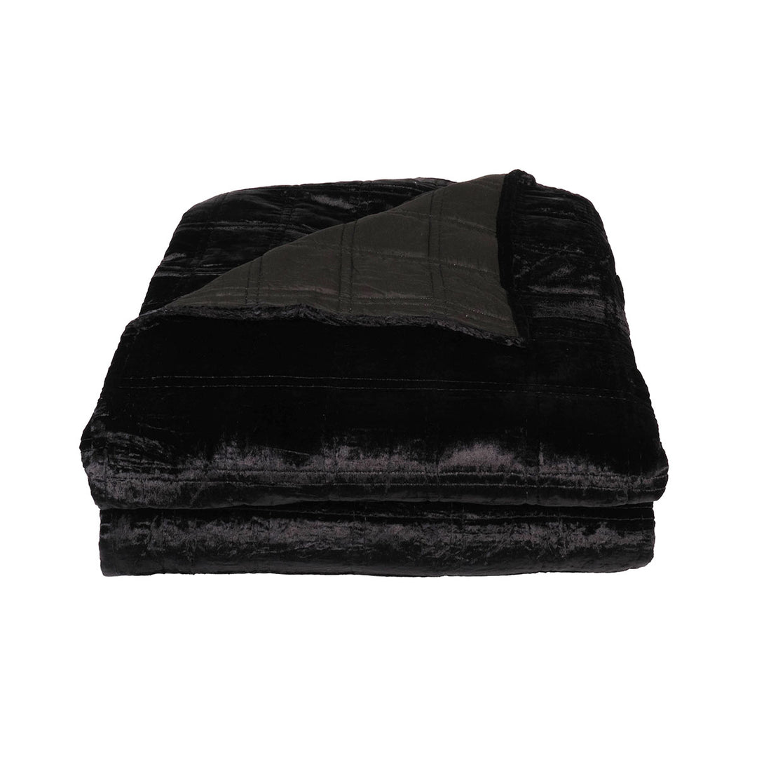 Black velvet box quilt on a bed. Dark velvet bedding. 