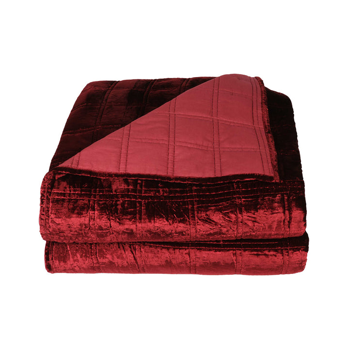 Red velvet box quilt on a white background. Dark, alternative velvet bedding. 