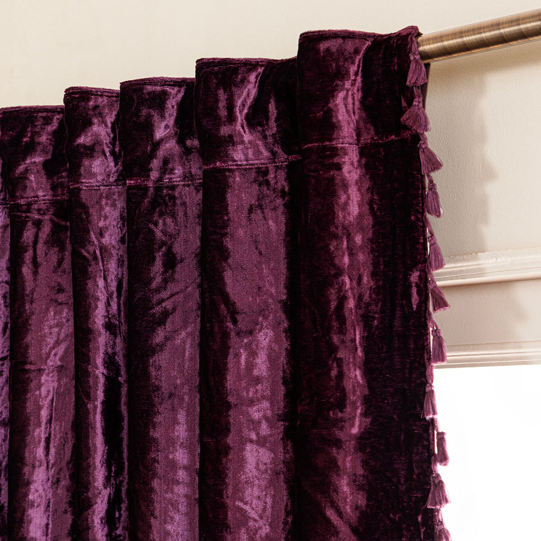 Close-up of purple velvet curtains with a neutral background