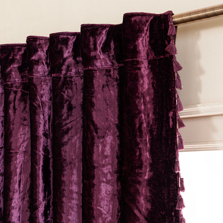 Close-up of purple velvet curtains with a neutral background